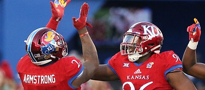 Kansas defensive end Dorance Armstrong Jr. (2), Kansas defensive tackle Daniel Wise (96) and Kansas linebacker Osaze Ogbebor (31) celebrate after Armstrong sacked Oklahoma quarterback Baker Mayfield (6) during the third quarter on Saturday, Nov. 18, 2017 at Memorial Stadium.