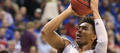 Kansas guard Devonte' Graham (4) pulls up for a shot over Toledo guard Marreon Jackson (3) during the first half on Tuesday, Nov. 28, 2017 at Allen Fieldhouse.