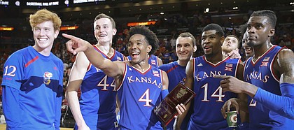 Kansas guard Devonte' Graham (4) holds the MVP trophy as he and the Jayhawks acknowledge the KU fans following their 76-60 win over Syracuse, Saturday, Dec. 2, 2017 at American Airlines Arena in Miami.