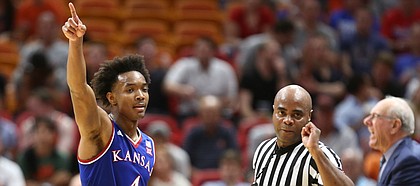 Kansas guard Devonte' Graham (4) signals the ball going the Jayhawks direction after forcing a Syracuse turnover during the second half, Saturday, Dec. 2, 2017 at American Airlines Arena in Miami.