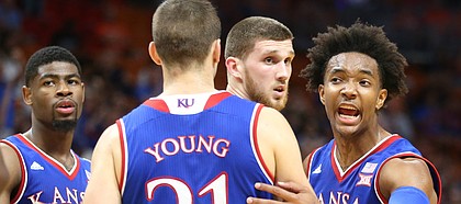 Kansas guard Devonte' Graham (4) pulls in his teammates during the first half, Saturday, Dec. 2, 2017 at American Airlines Arena in Miami.