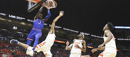Kansas guard Lagerald Vick (2) delivers on a lob jam over Syracuse forward Matthew Moyer (2) during the first half, Saturday, Dec. 2, 2017 at American Airlines Arena in Miami.