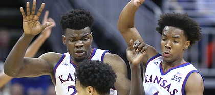 Kansas center Udoka Azubuike (35) and Kansas guard Devonte' Graham (4) try to trap Washington guard David Crisp (1) during the second half, Wednesday, Dec. 6, 2017 at Sprint Center.