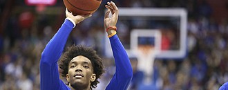 Kansas senior point guard Devonte' Graham throws up a shot in warmups prior to Saturday's game against Arizona State at Allen Fieldhouse.