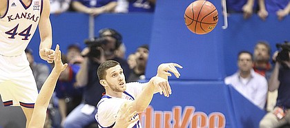 Kansas guard Sviatoslav Mykhailiuk (10) throws a pass from the floor after a steal from Omaha forward Matt Pile (40) during the first half on Monday, Dec. 18, 2017 at Allen Fieldhouse.
