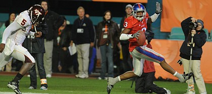 Kansas cornerback Aqib Talib high-steps into the end zone after picking off a pass during the first half as quarterback Tyrod Taylor (5) pursues. Talib was named MVP of the Jayhawks' 24-21 victory over Virginia Tech in the Orange Bowl on Thursday in Miami. Kansas University athletics officials have scheduled a free public event to celebrate the football team's Orange Bowl victory.