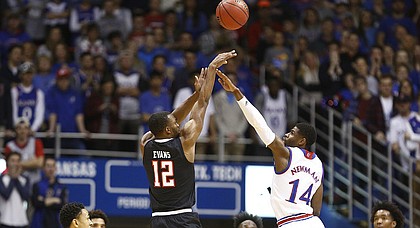 Texas Tech guard Keenan Evans (12) puts up a three over Kansas guard Malik Newman (14) during the first half, Tuesday, Jan. 2, 2018 at Allen Fieldhouse.