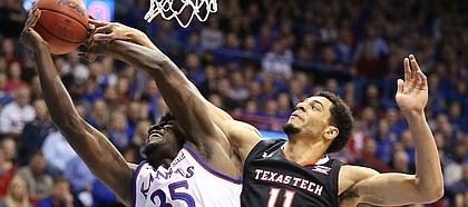 Kansas center Udoka Azubuike (35) is fouled on the shot by Texas Tech forward Zach Smith (11) during the first half, Tuesday, Jan. 2, 2018 at Allen Fieldhouse.