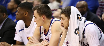 Kansas guard Sviatoslav Mykhailiuk, right, Kansas forward Mitch Lightfoot and forward Billy Preston watch the waning moments of the Jayhawks' 85-73 loss to Texas Tech, Tuesday, Jan. 2, 2018 at Allen Fieldhouse.