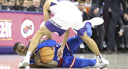 Kansas guard Lagerald Vick (2) wrestles for a ball with TCU guard Alex Robinson (25) during the second half, Saturday, Jan. 6, 2018 at Schollmaier Arena.