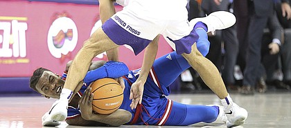 Kansas guard Lagerald Vick (2) wrestles for a ball with TCU guard Alex Robinson (25) during the second half, Saturday, Jan. 6, 2018 at Schollmaier Arena.