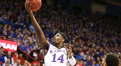 Kansas guard Malik Newman (14) floats in for a bucket during the first half, Tuesday, Jan. 9, 2018 at Allen Fieldhouse. Pictured are Iowa State guard Lindell Wigginton (5) and Iowa State guard Nick Weiler-Babb (1).