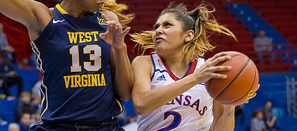 Kansas guard Brianna Osorio (2) tries to push past West Virginia forward Kristina King (13) late in the second quarter of Wednesday's game at Allen Fieldhouse.