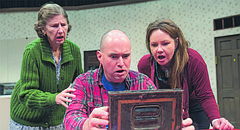 Actor Brian Williams, as Jimmy Nowak, slowly opens a box of family letters as Carole Ries, left, playing Clara Nowak, and Hailey Gillespie, right, playing Ruth Nowak, watch in anticipation in a scene from the comedy “Miracle on South Division Street”. The play opens Friday, Jan. 19, 2018 at Theatre Lawrence.