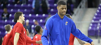 Kansas forward Billy Preston dribbles a ball at half court as his teammates get stretched prior to tipoff against TCU, Saturday, Jan. 6, 2018 at Schollmaier Arena.