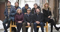 Many of the Lawrence Songbook collaborators are pictured on Thursday, Jan. 18, 2018. Sitting at left is songbook committee member and musical artist Jeff Stolz, Lawrence Public Library director of development and community partnerships Kathleen Morgan, songbook creator and Lawrence artist Nicholas Ward, Lawrence Public Library executive director Brad Allen, and songbook committee member and Lawrence musician Heidi Lynn Gluck. In back from left are songbook illustrator Adam Lott, songbook committee member and musical artist Sean Hunt, a.k.a Approach, and songbook visual art director Nicholas Stahl.