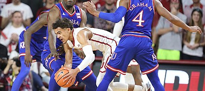 Kansas guard Devonte' Graham (4) and Kansas center Udoka Azubuike (35) look to tie up Oklahoma guard Trae Young (11) during the first half at Lloyd Noble Center on Tuesday, Jan. 23, 2018 in Norman, Oklahoma.