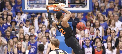 Oklahoma State forward Cameron McGriff (12) delivers a dunk during the second half, Saturday, Feb. 3, 2018 at Allen Fieldhouse.