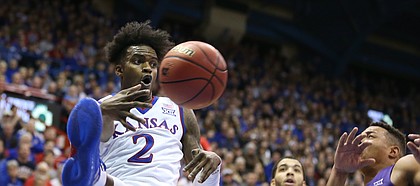Kansas guard Lagerald Vick (2) throws a pass across the baseline beyond TCU guard Kenrich Williams (34) and TCU guard Desmond Bane (1) during the second half on Tuesday, Feb. 6, 2018 at Allen Fieldhouse.