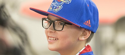 Tayber Witt, an 11-year-old from Tonganoxie smiles as he takes questions from media members following Kansas football head coach David Beaty's National Signing Day press conference on Wednesday, Feb. 7, 2018 at the Anderson Family Football Complex. Witt, who lives with a genetic disorder, became an unofficial member of the team and will attend practices, games and team functions.