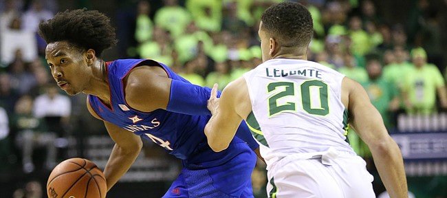 Kansas guard Devonte' Graham (4) tries to get around Baylor Bears guard Manu Lecomte (20) during the first half, Saturday, Feb. 11, 2018 at Ferrell Center in Waco, Texas.