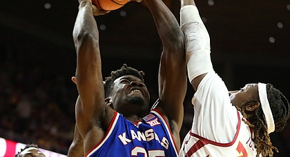 Kansas center Udoka Azubuike (35) bangs inside for a bucket and a foul from Iowa State forward Solomon Young (33) during the first half, Tuesday, Feb. 13, 2018 at Hilton Coliseum in Ames, Iowa. In back is Iowa State forward Cameron Lard (2).