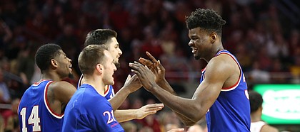 Kansas center Udoka Azubuike, right, is congratulated by his teammates after a string of buckets during the second half, Tuesday, Feb. 13, 2018 at Hilton Coliseum in Ames, Iowa.