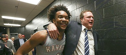 Kansas guard Devonte' Graham (4) and Kansas head coach Bill Self walk arm in arm down the hallway to the locker room following the Jayhawks' 74-72 win over Texas Tech on Saturday, Feb. 24, 2018 at United Supermarkets Arena.