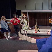 Sicily Rees and Alan Martin, center foreground, join an ensemble cast during rehearsals of Theatre Lawrence’s production of “Ring of Fire.” In the background, from left, are cast members Chelsea Watgen, Ryan Nichols, Julia Peterson, Russ Baker, Chris Hatfield and Katherine Bettis. The production opens March 2.