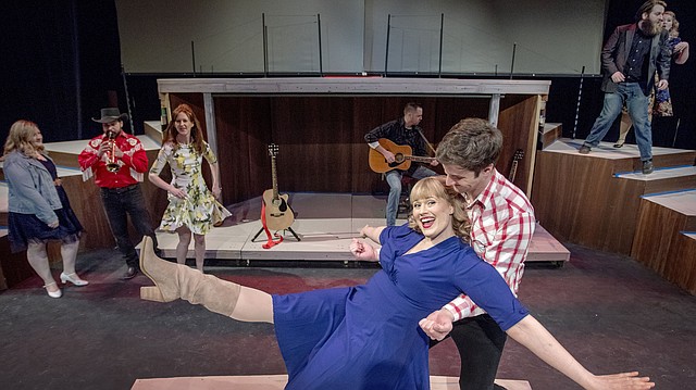 Sicily Rees and Alan Martin, center foreground, join an ensemble cast during rehearsals of Theatre Lawrence’s production of “Ring of Fire.” In the background, from left, are cast members Chelsea Watgen, Ryan Nichols, Julia Peterson, Russ Baker, Chris Hatfield and Katherine Bettis. The production opens March 2.