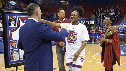 Kansas forward Chayla Cheadle hugs coach Brandon Schneider during the senior recognition on Tuesday, Feb. 27, 2018. Iowa State outscored KU 65-56.