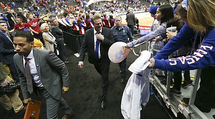 Kansas head coach Bill Self loosens his tie as he makes his way from the court following the Jayhawks' 82-68 win over Oklahoma State, Thursday, March 8, 2018 at Sprint Center in Kansas City, Mo.