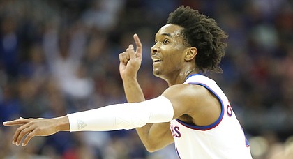 Kansas guard Devonte' Graham (4) looks for a shot to fall during the first half, Thursday, March 8, 2018 at Sprint Center in Kansas City, Mo.