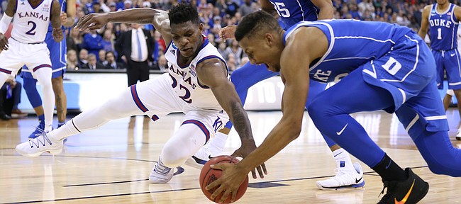 Kansas forward Silvio De Sousa (22) and Duke forward Javin DeLaurier (12) fight for a ball during the second half, Sunday, March 25, 2018 at CenturyLink Center in Omaha, Neb.