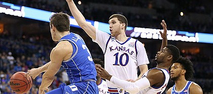Duke guard Grayson Allen (3) throws a pass beyond Kansas guard Sviatoslav Mykhailiuk (10) and Kansas guard Malik Newman (14) during the first half, Sunday, March 25, 2018 at CenturyLink Center in Omaha, Neb.