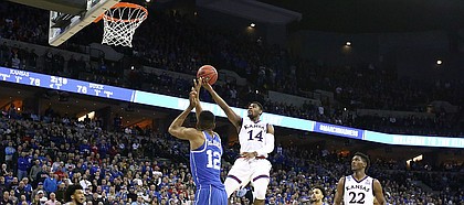 Kansas guard Malik Newman (14) floats in to the bucket against Duke forward Javin DeLaurier (12) during the second half, Sunday, March 25, 2018 at CenturyLink Center in Omaha, Neb.