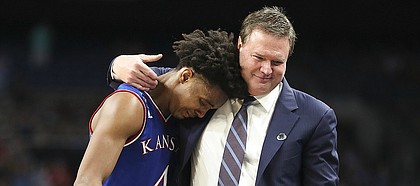 Kansas head coach Bill Self puts his arm around a tearful Devonte' Graham (4) as Graham checks out of the game with seconds remaining, Saturday, March 31, 2018 at the Alamodome in San Antonio, Texas.