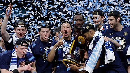 Villanova players celebrate with the trophy after beating Michigan, 79-62, in the championship game of the Final Four NCAA Tournament on Monday, April 2, 2018, in San Antonio.
