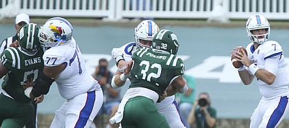 Kansas offensive lineman Andru Tovi (77) and Kansas offensive lineman Mesa Ribordy work to push aside Ohio defensive lineman Will Evans (51) and Ohio linebacker Quentin Poling (32) as Kansas quarterback Peyton Bender (7) looks to throw during the first quarter on Saturday, Sept. 16, 2017 at Peden Stadium in Athens, Ohio.