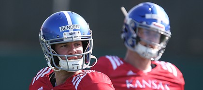 Kansas quarterback Peyton Bender (7) drops back to pass during practice on Wednesday, April 4, 2018, as Carter Stanley (9) observes.