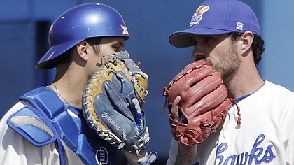 Kansas catcher Jaxx Groshans, left, visits with starting pitcher Taylor Turski in the early innings of the Jayhawks' home game against Texas Tech, Saturday, April 7, 2018, at Hoglund Ballpark. KU fell to Texas Tech, 10-0.
