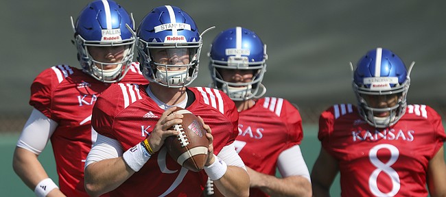 Kansas quarterback Carter Stanley clutches the ball as he prepares to throw during practice on Tuesday, April 10, 2018.