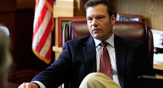 In this Wednesday, May 17, 2017 photo, Kansas Secretary of State Kris Kobach talks with a reporter in his office in Topeka, Kan. (AP Photo/Orlin Wagner)