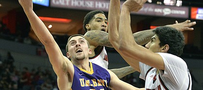 Albany guard Joe Cremo (24) attempts a layup past the defense of Louisville forward Ray Spalding (13), and forward Anas Mahmoud (14) during the first half of an NCAA college basketball game, Wednesday, Dec. 20, 2017, in Louisville, Ky.