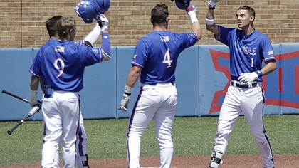 Kansas sophomore Benjamin Sems, right, is greeted at home plate by Owen Taylor (4), center, and James Cosentino (9) left, after Sems hit a home run in the 5th inning to give KU a 2-1 lead against West Virginia, Sunday at Hoglund Ballpark. The Jayhawks won the game 5-2 with additional home runs from both Cosentino and Taylor.