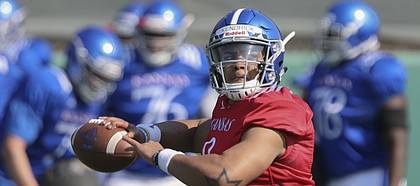 Kansas sophomore quarterback Miles Kendrick pulls back to throw during practice on Tuesday, April 10, 2018.