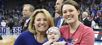 Kansas head coach Bill Self's wife Cindy, daughter Lauren and granddaughter, Ella, are pictured as the Jayhawks celebrate a trip to the Final Four following their 85-81 overtime victory over Duke on Sunday, March 25 in Omaha, Neb.