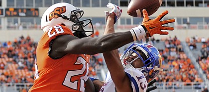 Kansas corner back Hasan Defense (13) interrupts a pass to Oklahoma St wide receiver James Washington (28) in the Oklahoma St end zone during a NCAA college football game in Stillwater, Okla., Saturday, Nov. 25, 2017.