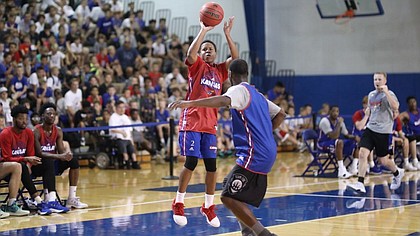 Red Team guard Charlie Moore puts up a three over Blue Team guard Elijah Johnson during a scrimmage on Wednesday, June 13, 2018, at the Horejsi Family Athletics Center.