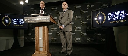 FILE — Bowl Championship Series executive director Bill Hancock, left, and former Arkansas athletic director Jeff Long, chairman of the College Football Playoff Committee, announce the 12 members selected to the committee during a news conference, Wednesday, Oct. 16, 2013, in Irving, Texas. The University of Kansas announced Long as its new athletic director on July 5, 2018. (AP Photo/Tony Gutierrez)